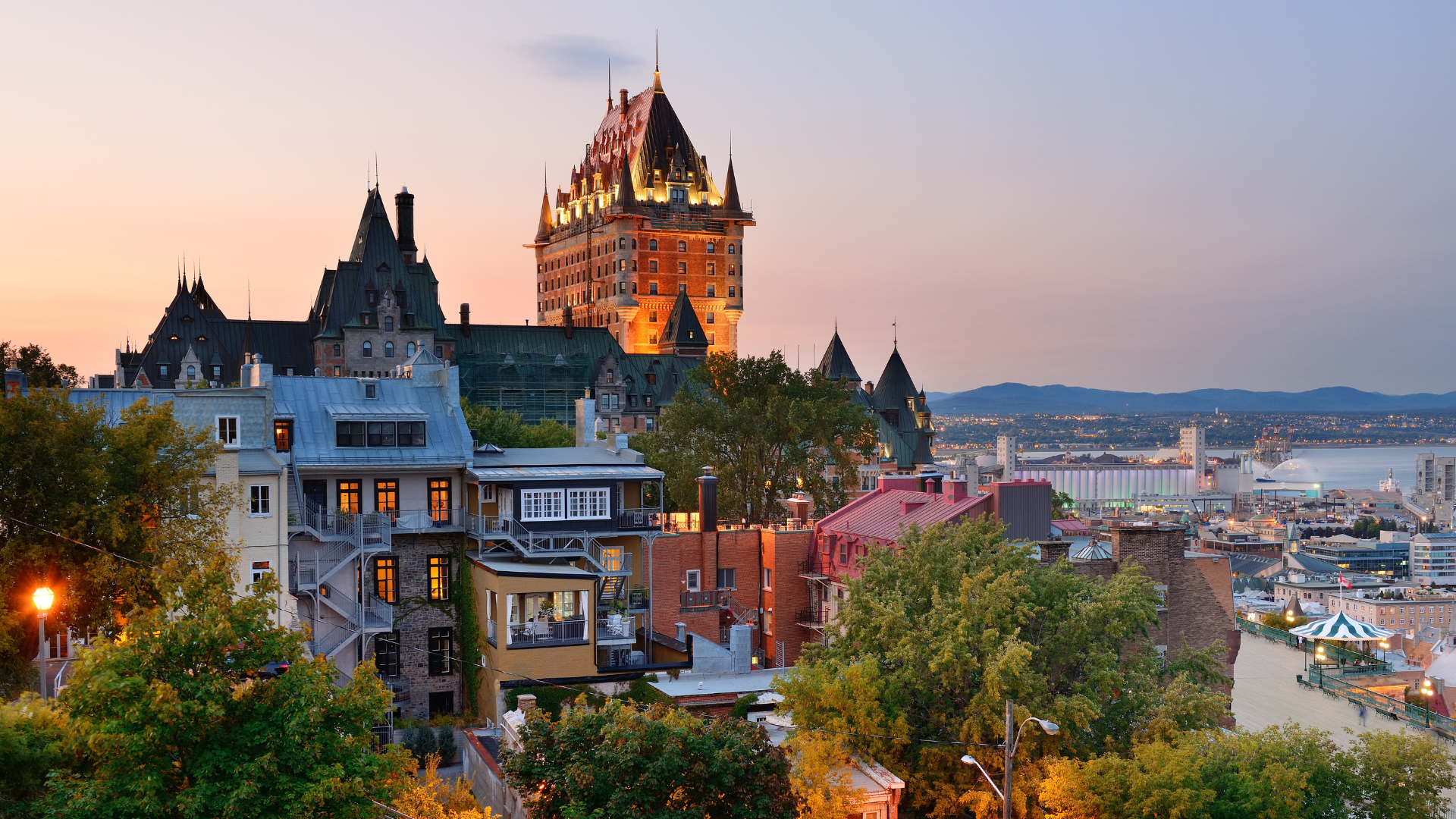 Night skyline of Montréal with Mount Royal and city lights reflecting on the Saint Lawrence River